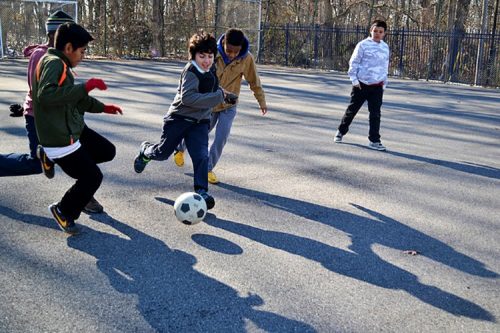 boys playing soccer at recess