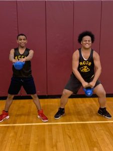 high school PE students with kettlebells