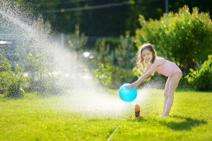 girl in sprinkler