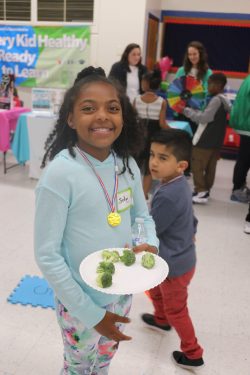 girl eating broccoli